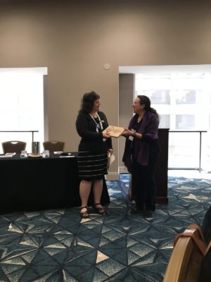 Past-Chair Deb Mollen presenting Laura Brown with the Foremother of the Year award